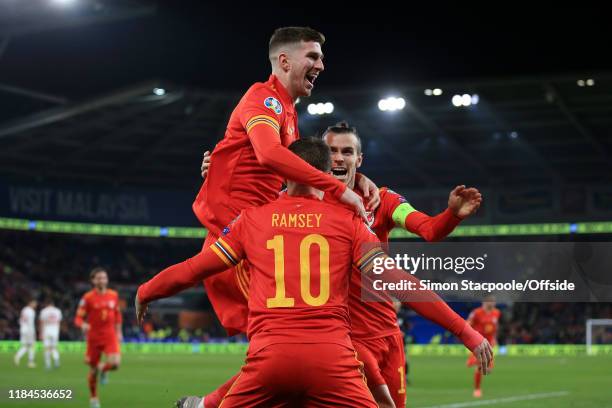Aaron Ramsey of Wales celebrates with teammates Chris Mepham of Wales and Gareth Bale of Wales after scoring their 2nd goal during the UEFA Euro 2020...