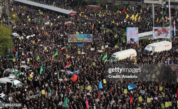 Demonstrators gather during a pro-government demonstration to react to protests due to fuel price increase of Iran, on November 25, 2019 in Tehran,...