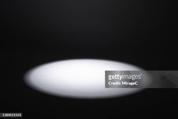 illuminated spotlight in the dark - spotlit fotografías e imágenes de stock