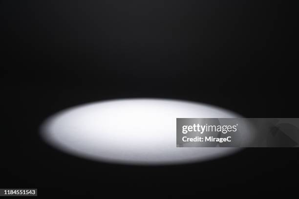 illuminated spotlight in the dark - spotlight imagens e fotografias de stock