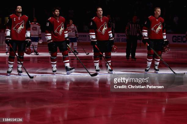 Oliver Ekman-Larsson, Jason Demers, Christian Fischer and Carl Soderberg of the Arizona Coyotes stand attended for the Canadian national anthem...