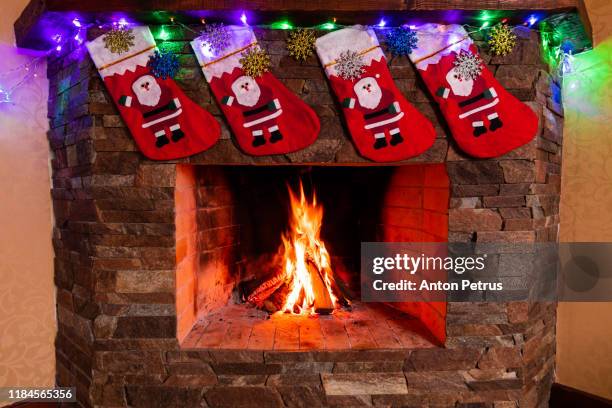 fireplace with beautiful christmas decorations - socks fireplace stock pictures, royalty-free photos & images