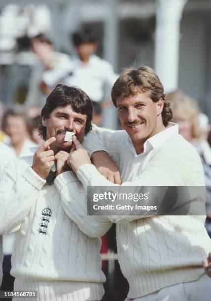 England players Ian Botham and Allan Lamb share a joke after the 4th Test Match between England at New Zealand at Trent Bridge on August 29, 1983 in...