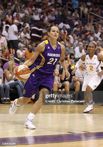 Ticha Penicheiro of the Los Angeles Sparks handles the ball during the WNBA game against the Phoenix Mercury at US Airways Center on July 5, 2011 in...