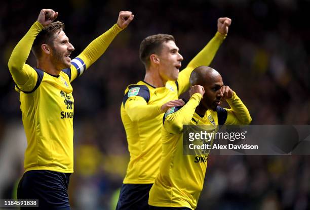 Rob Hall of Oxford United celebrates scoring his sides first goal with James Henry and Josh Ruffels during the Carabao Cup Round of 16 match between...