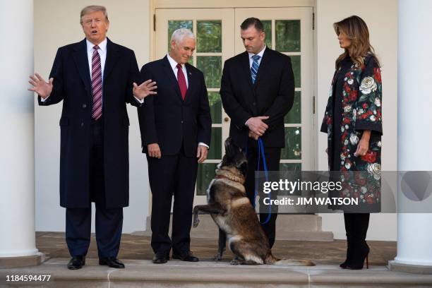 President Donald Trump , Vice President Mike Pence and First Lady Melania Trump stand with Conan, the military dog that was involved with the death...