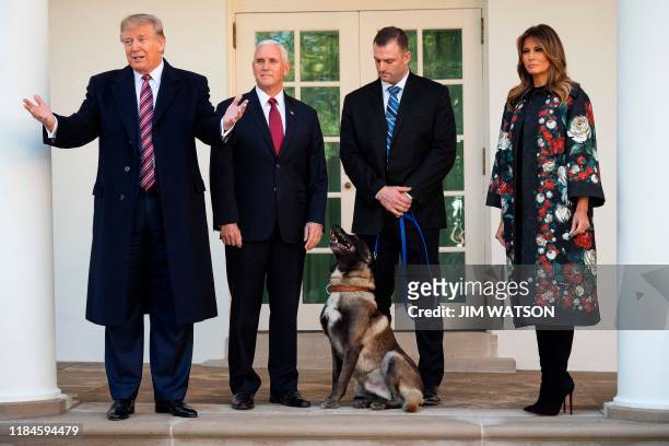 President Donald Trump , Vice President Mike Pence and First Lady Melania Trump stand with Conan, the military dog that was involved with the death...
