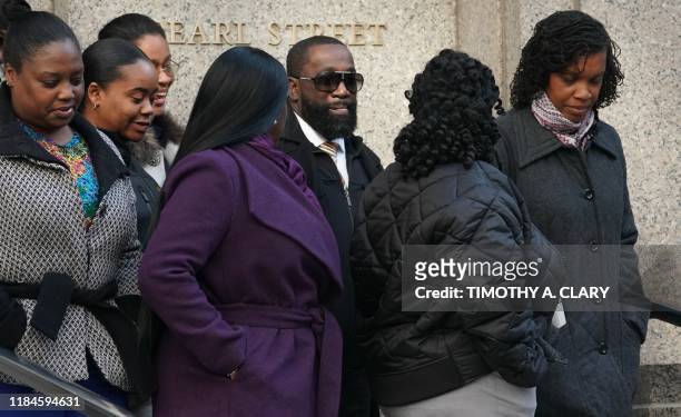 Metropolitan Correctional Center guard Michael Thomas surrounded by supporters leaves Federal Court in New York City on November 25, 2019. - Michael...