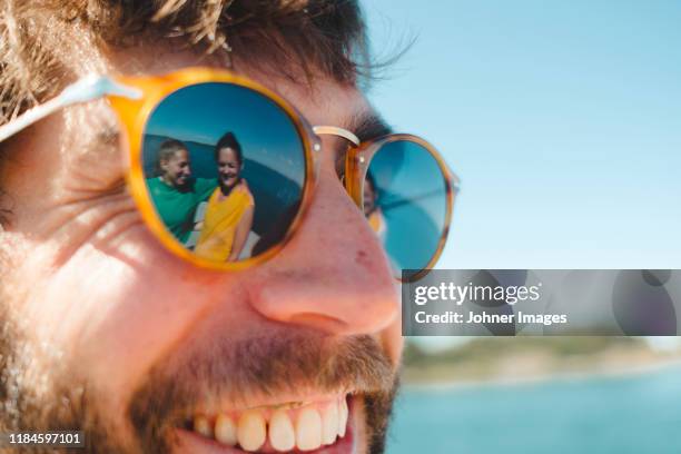 women reflecting in mans sunglasses - sunglasses reflection stock pictures, royalty-free photos & images