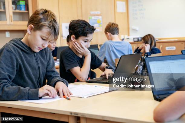boys using laptops at school - using laptop stock pictures, royalty-free photos & images