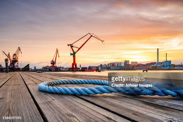 rope on wooden deck, port on background - gothenburg sweden stock pictures, royalty-free photos & images