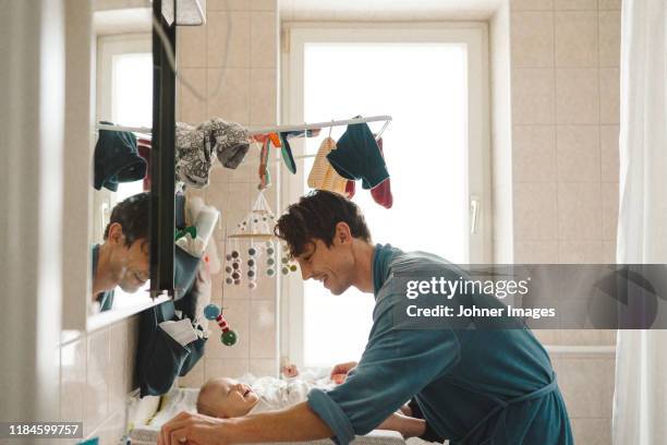 father with baby - diaper change stock-fotos und bilder