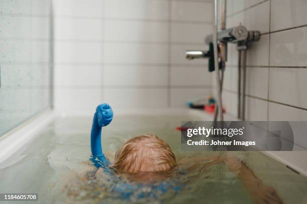 child wearing snorkel in bathtub - ofog bildbanksfoton och bilder