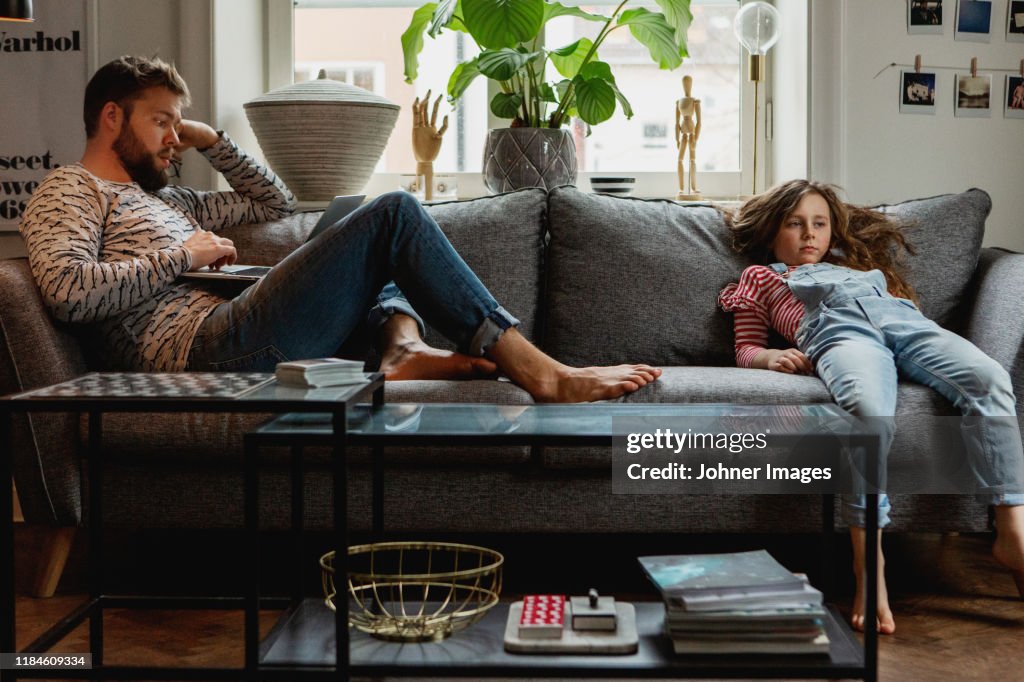 Father and daughter on sofa