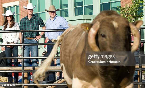 Catherine, Duchess of Cambridge, Prince William, Duke of Cambridge and Canadian Prime Minister Stephen Harper watch a rodeo demonstration at a...