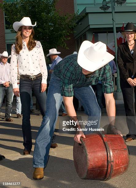 Catherine, Duchess of Cambridge looks on as Prince William, Duke of Cambridge throws a barrel at Government Reception at the BMO Centre on day 8 of...