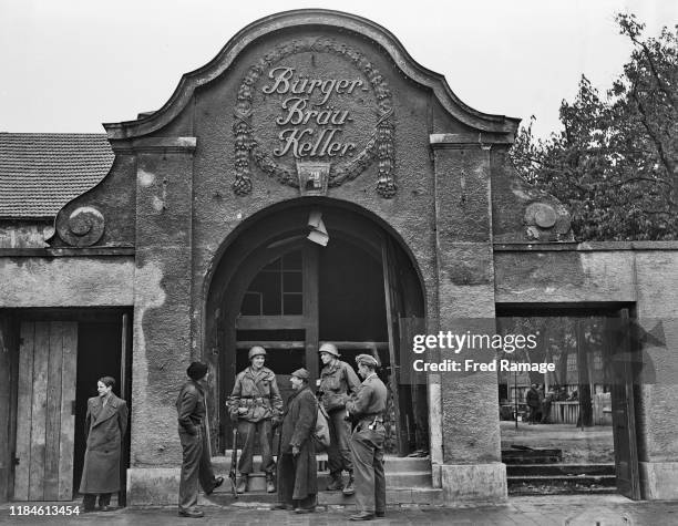 Privates Samuel Banz and Edward de Young of the United States Army and Chicago, USA talk with two recently released prisoners of war outside the...