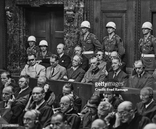 Nazi defendant Hermann Goering in the dock behind the defence counsel, under guard in Room 600 at the Palace of Justice in Nuremberg during legal...
