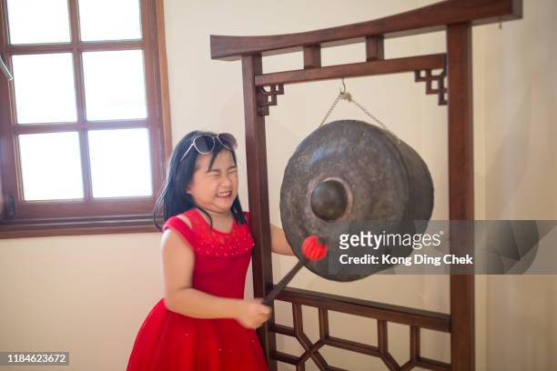girl knock gong - gong stock pictures, royalty-free photos & images