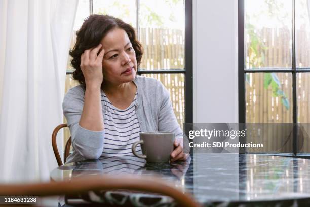 emotionally stressed senior woman - staring up stock pictures, royalty-free photos & images