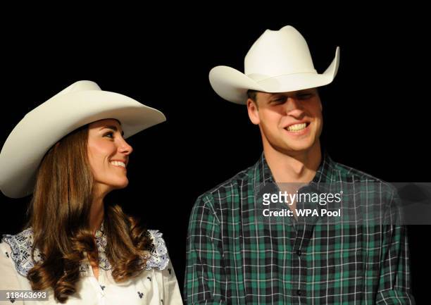 Catherine, Duchess of Cambridge and Prince William, Duke of Cambridge wear their new Smithbilt cowboy hats as they watch a rodeo demonstration at a...
