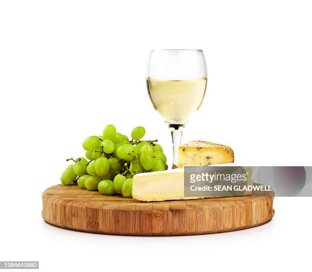 white wine and cheese board - cheese plate stock-fotos und bilder