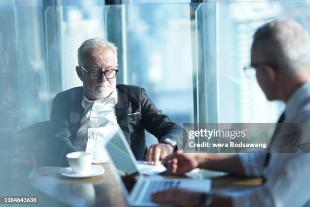 chief executive officer reading employment contract agreement - lawyers serious stock pictures, royalty-free photos & images