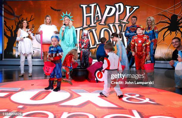 Fox anchors Jedediah Bila, Carley Shimkus, Janice Dean, Pete Hegseth, Jennifer Rauchet and children participate in "Fox & Friends" Halloween...
