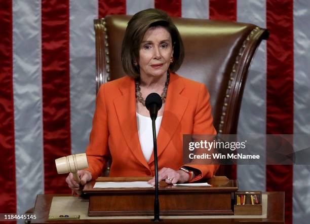 Speaker of the House Nancy Pelosi gavels the close of a vote by the U.S. House of Representatives on a resolution formalizing the impeachment inquiry...