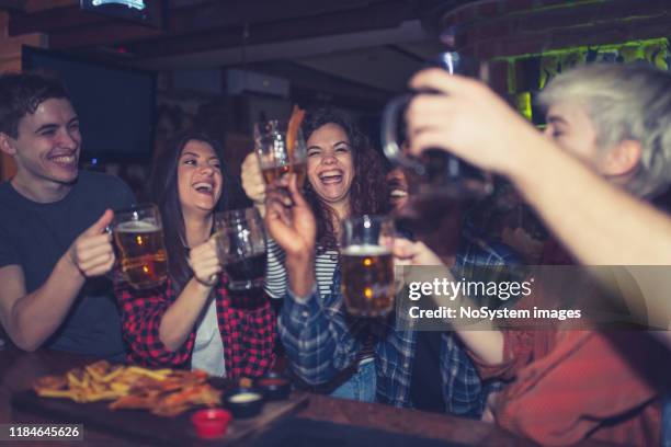 friends drinking beer in the pub - belgrade serbia stock pictures, royalty-free photos & images