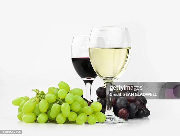 two glasses of red and white wine - wine grapes stock pictures, royalty-free photos & images