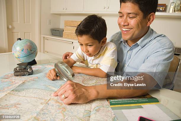 hispanic dad & boy - globe showing north america stock pictures, royalty-free photos & images