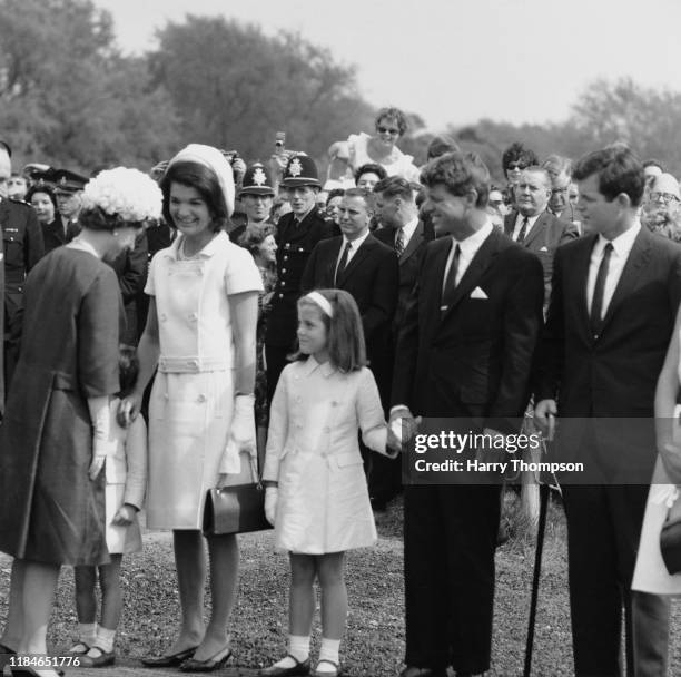 Queen Elizabeth II meets Jackie Kennedy, the widow of US President John F Kennedy, and her children John Jr and Caroline during a ceremony to unveil...