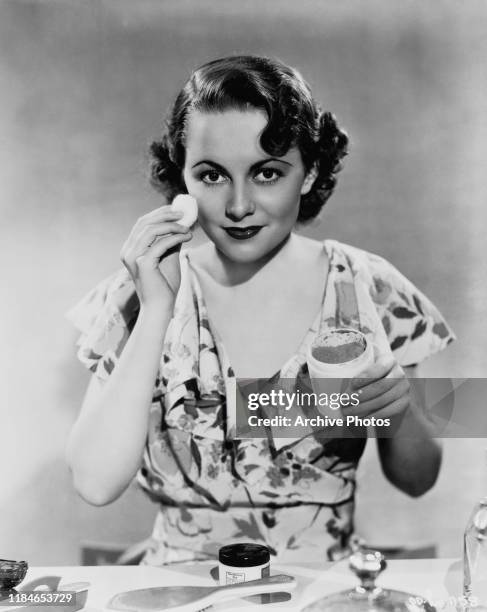 Actress Olivia de Havilland applying her make-up, circa 1935.