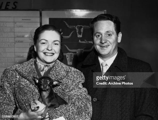 American jazz musician Les Paul and his wife, singer and guitarist Mary Ford prepare to board an American Airlines flagship plane at Idlewild Airport...