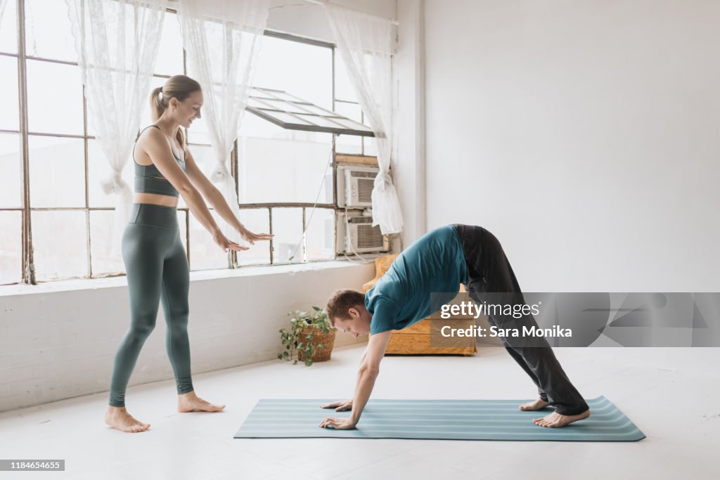 Yoga instructor teaching yoga in studio
