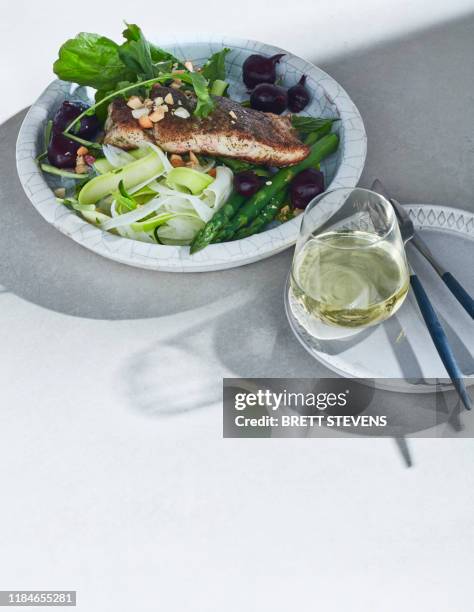 high key still life with barramundi lemon myrtle and native spices on white table - barramundi stock pictures, royalty-free photos & images