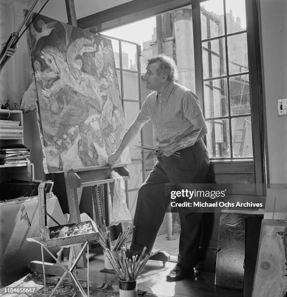 Russian-French artist Marc Chagall at work on one of his circus paintings, circa 1942.