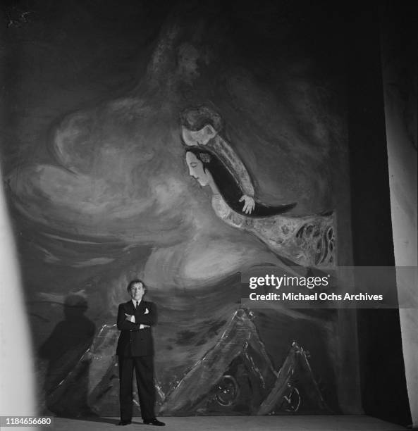 Russian-French artist Marc Chagall with one of his paintings, circa 1942.