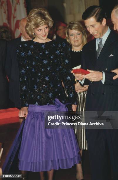 Prince Charles and Diana, Princess of Wales attend the Mayor's dinner during a visit to Florence, Italy, April 1985. Diana is wearing a black and...