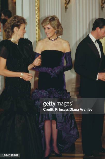 Prince Charles and Diana, Princess of Wales attend the opera in Munich, Germany, November 1987. Diana is wearing a purple strapless gown by Catherine...