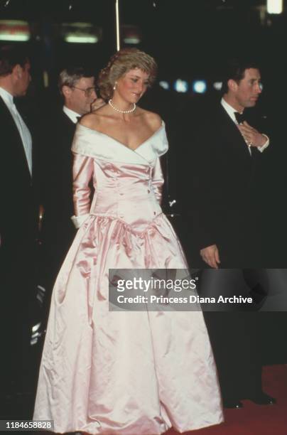 Prince Charles and Diana, Princess of Wales attend the ballet in Berlin, Germany, November 1987. Diana is wearing an evening gown by Catherine Walker.