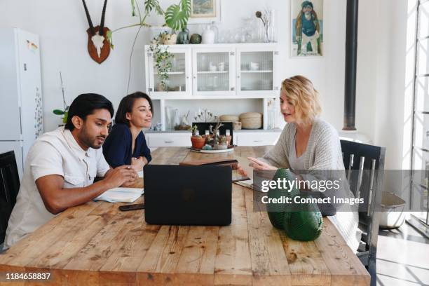 colleagues having discussion in office - indian ethnicity south africa stock pictures, royalty-free photos & images