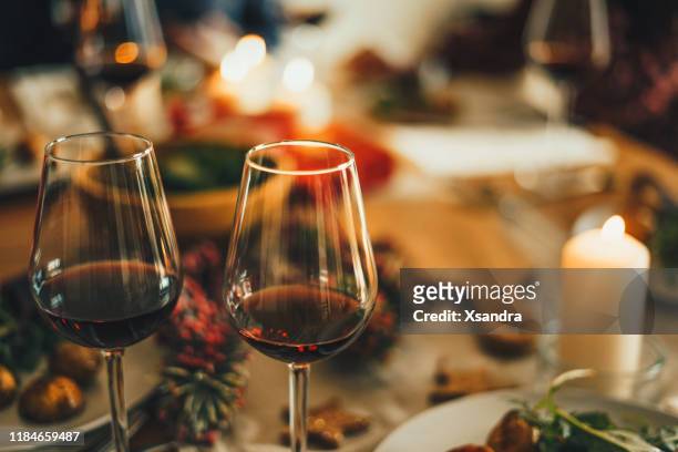 クリスマスディナーテーブルでの赤ワイン - wine party ストックフォトと画像