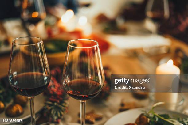 red wine at the christmas dinner table - party and winter stock pictures, royalty-free photos & images