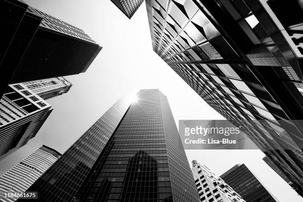 skyscrapers from below, lower manhattan. - black and white stock pictures, royalty-free photos & images