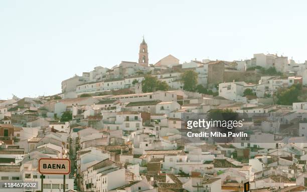 a typical andalusian village with hilltop church - baena stock-fotos und bilder