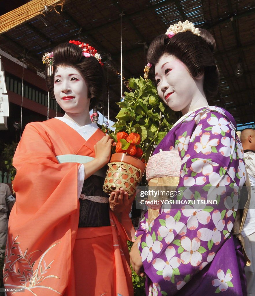 Japanese girls Yanagi (L) and Chiyo hold