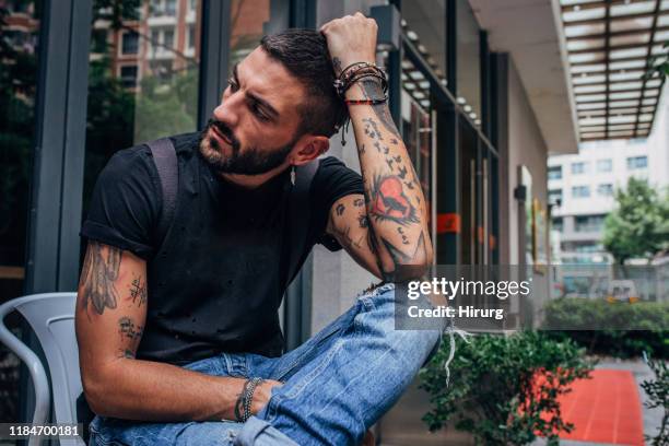 worried young man - ripped jeans stock pictures, royalty-free photos & images