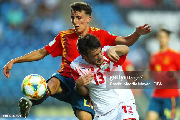 Alejandro Frances of Spain clears the ball around Amadoni Kamolov of Tajikistan during the FIFA U-17 World Cup Brazil 2019 group E match between...